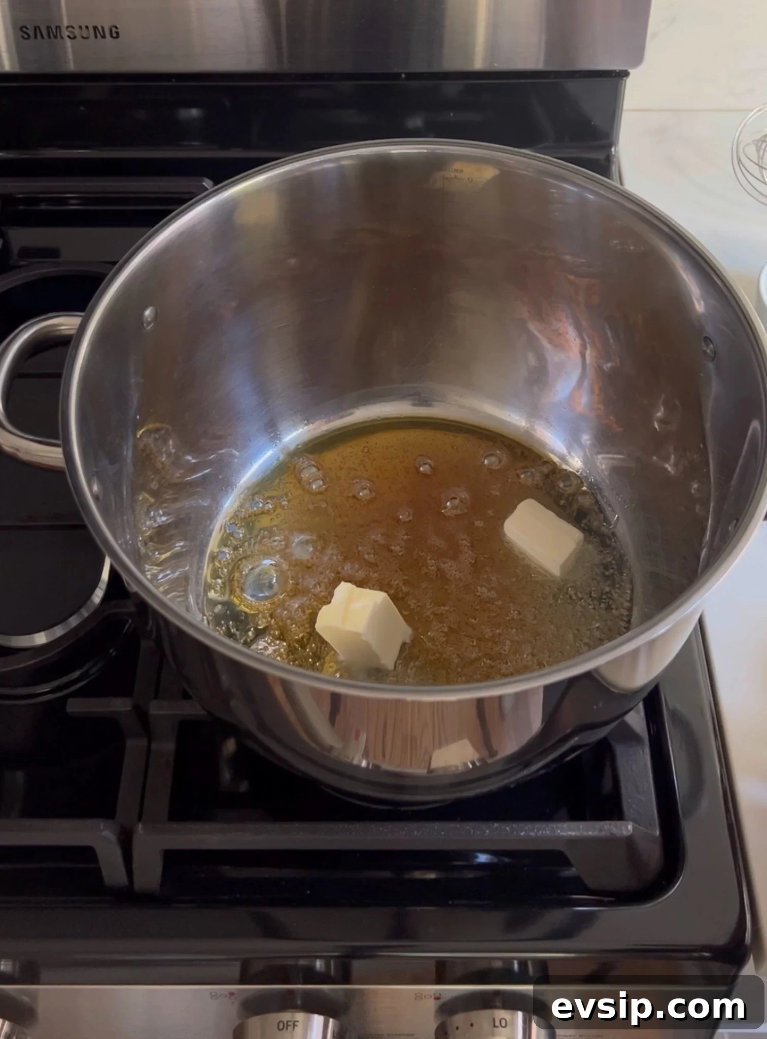 Adding butter to caramelized sugar.