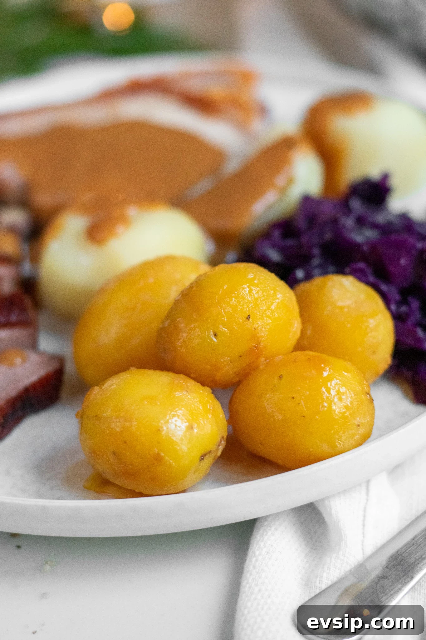 Caramelized potatoes on a plate with roast Christmas dinner.