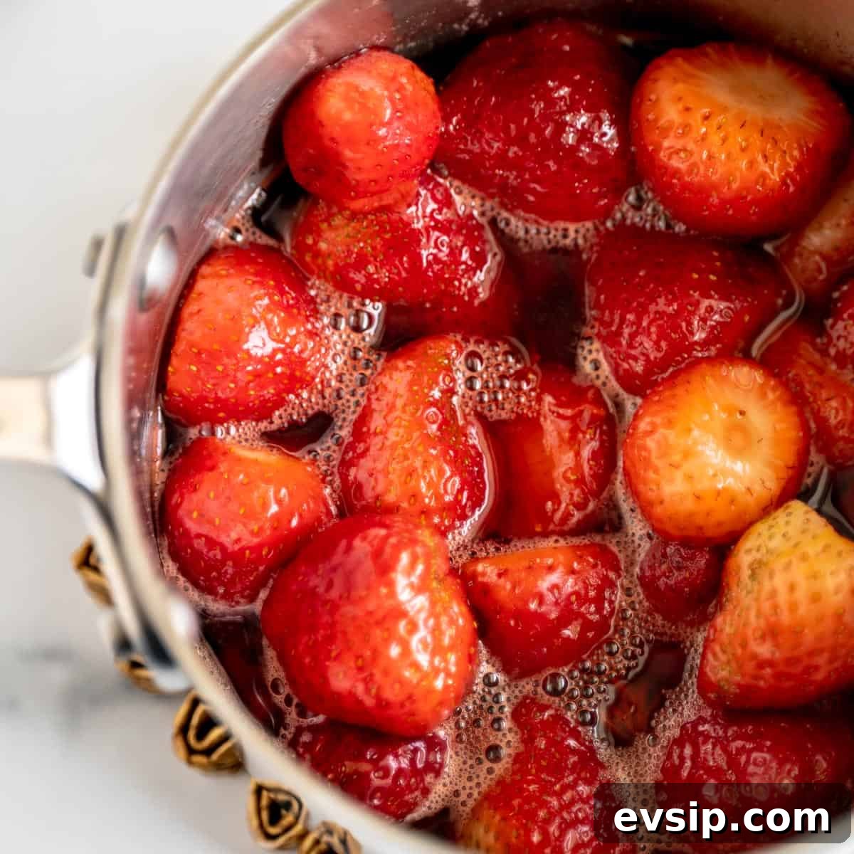 Homemade Strawberry Compote: Quick Recipe for Desserts 6 A pot of strawberries submerged in liquid.