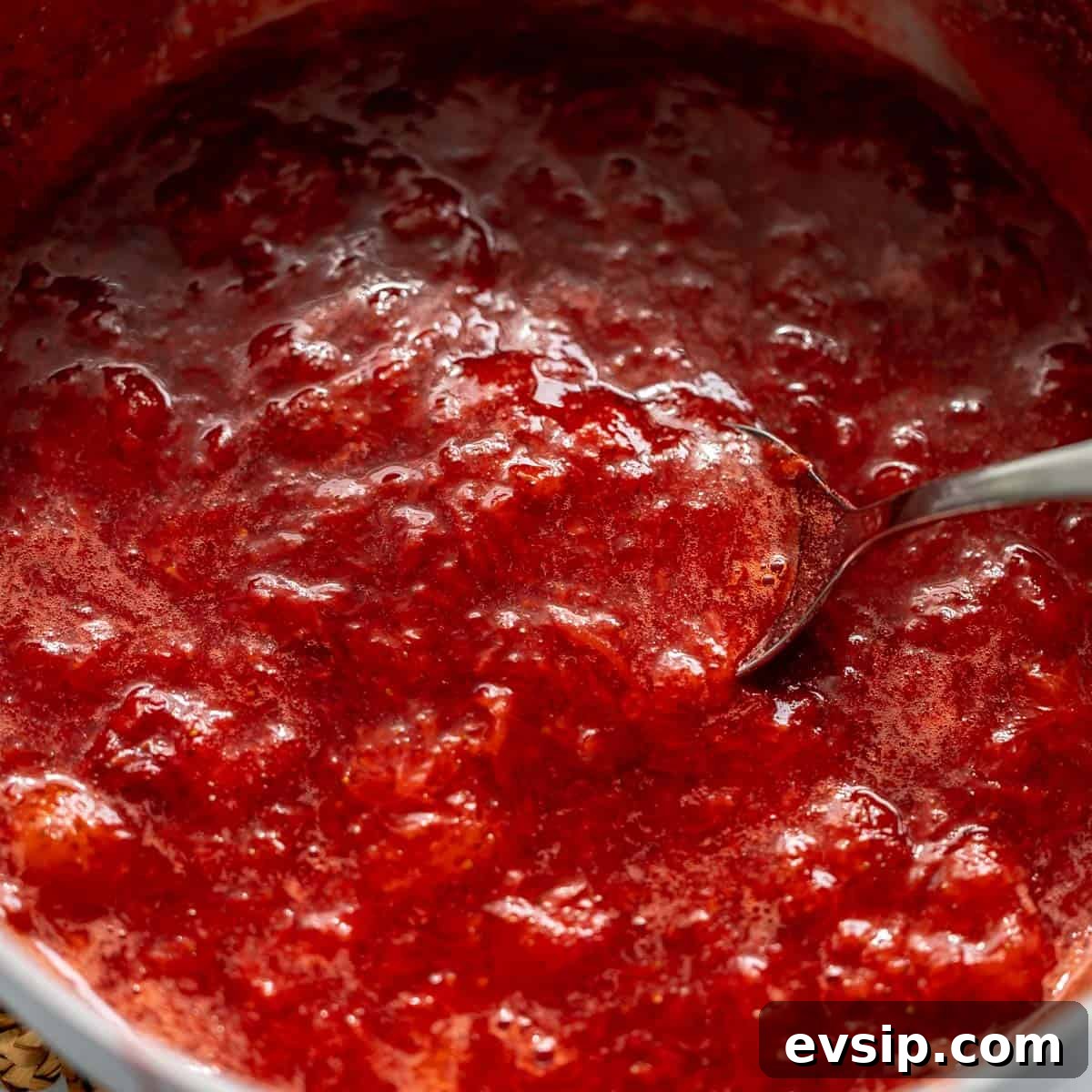 Homemade Strawberry Compote: Quick Recipe for Desserts 8 A spoon stirring a pot of strawberry compote