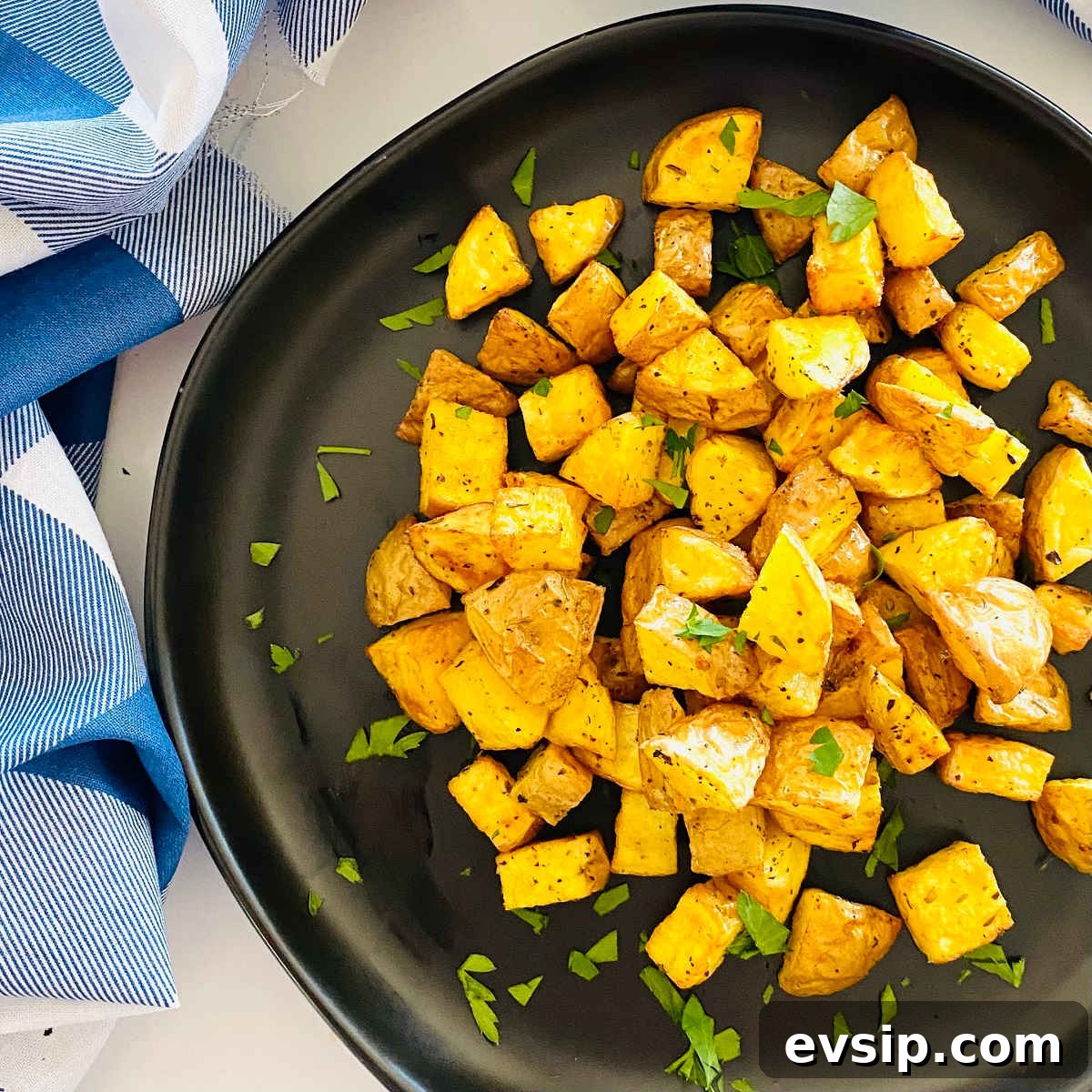Crispy Air Fryer Diced Potatoes You’ll Love 6 air fryer diced potatoes on a plate with parsley garnish