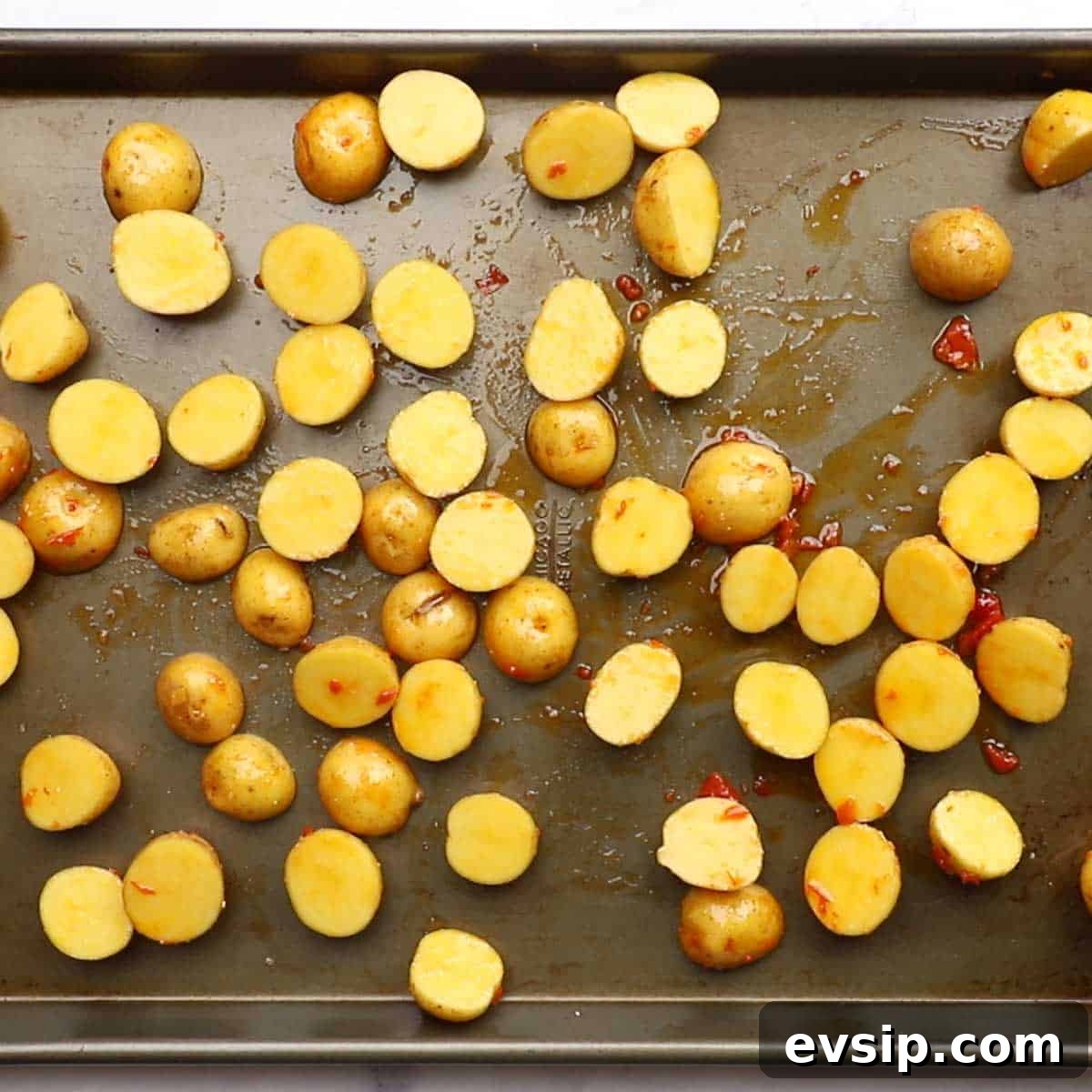 potatoes spread on a baking sheet