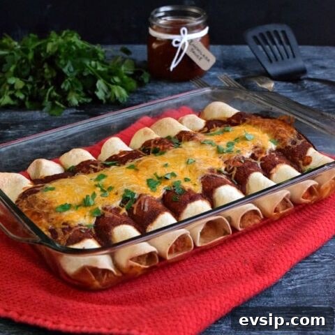 Side view of casserole dish full of leftover chicken enchiladas