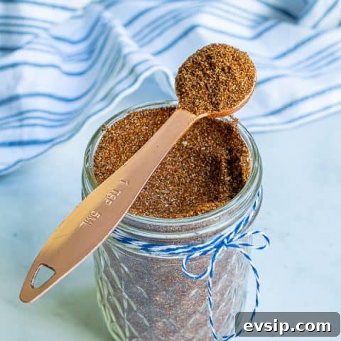 spoon full of taco seasoning simple resting on a jar full of taco seasoning