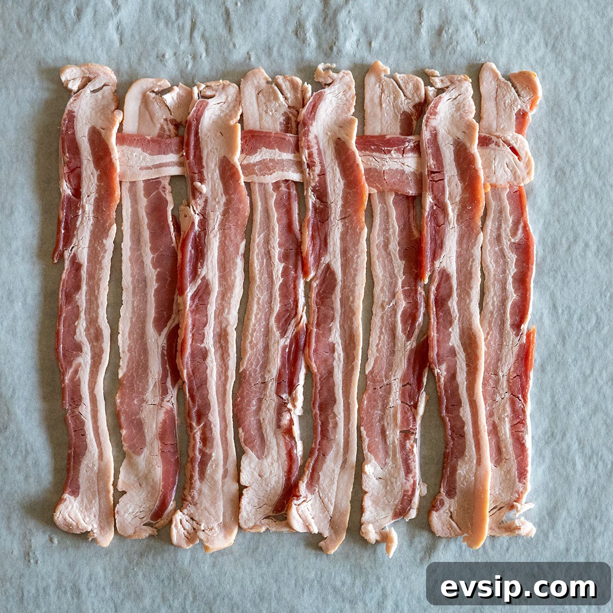 slice of bacon weaved across top part of bacon.