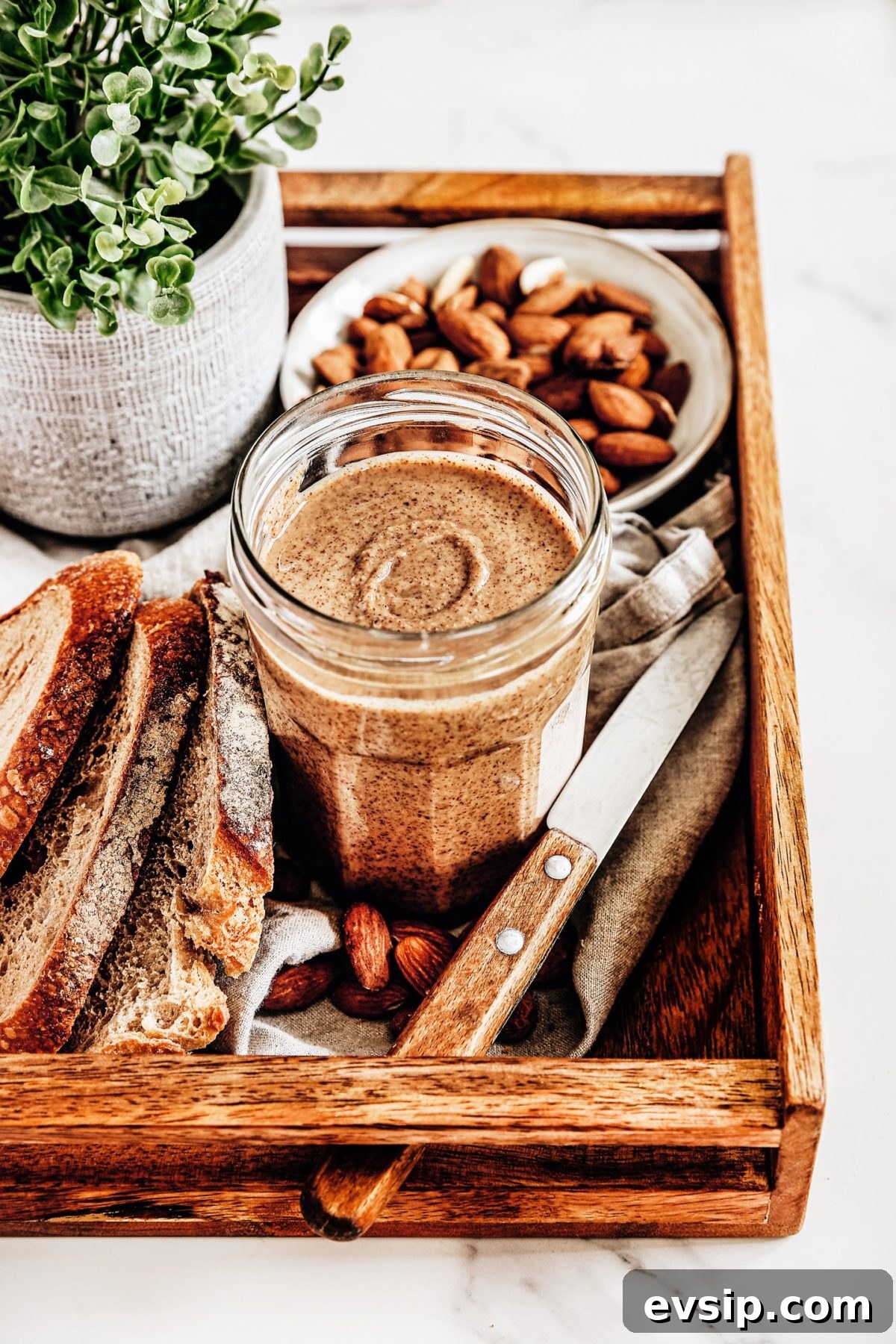 almond butter on a jar on a board tray