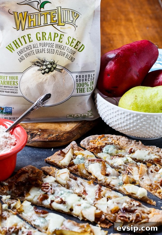 Caramelized Onion and Cheese Flatbreads for Entertaining 5 Cheesy Caramelized Flatbread with pears, blue cheese, and pecans. Made with White Lily Premium White Grape Seed Blend Flour.