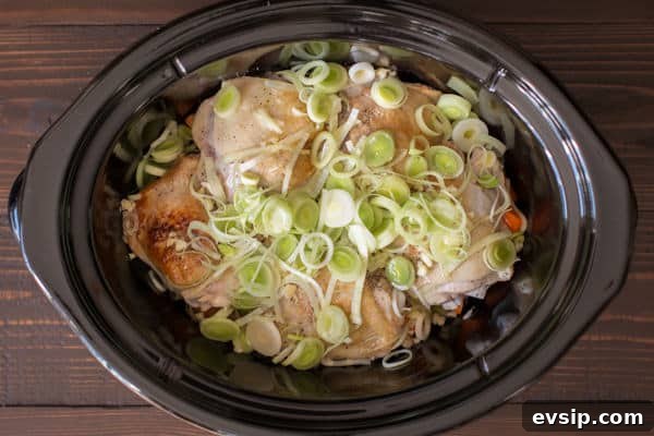 chicken thighs with raw leeks on the top.