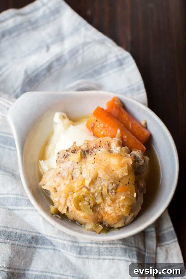 bowl with mashed potatoes, carrots and chicken thigh