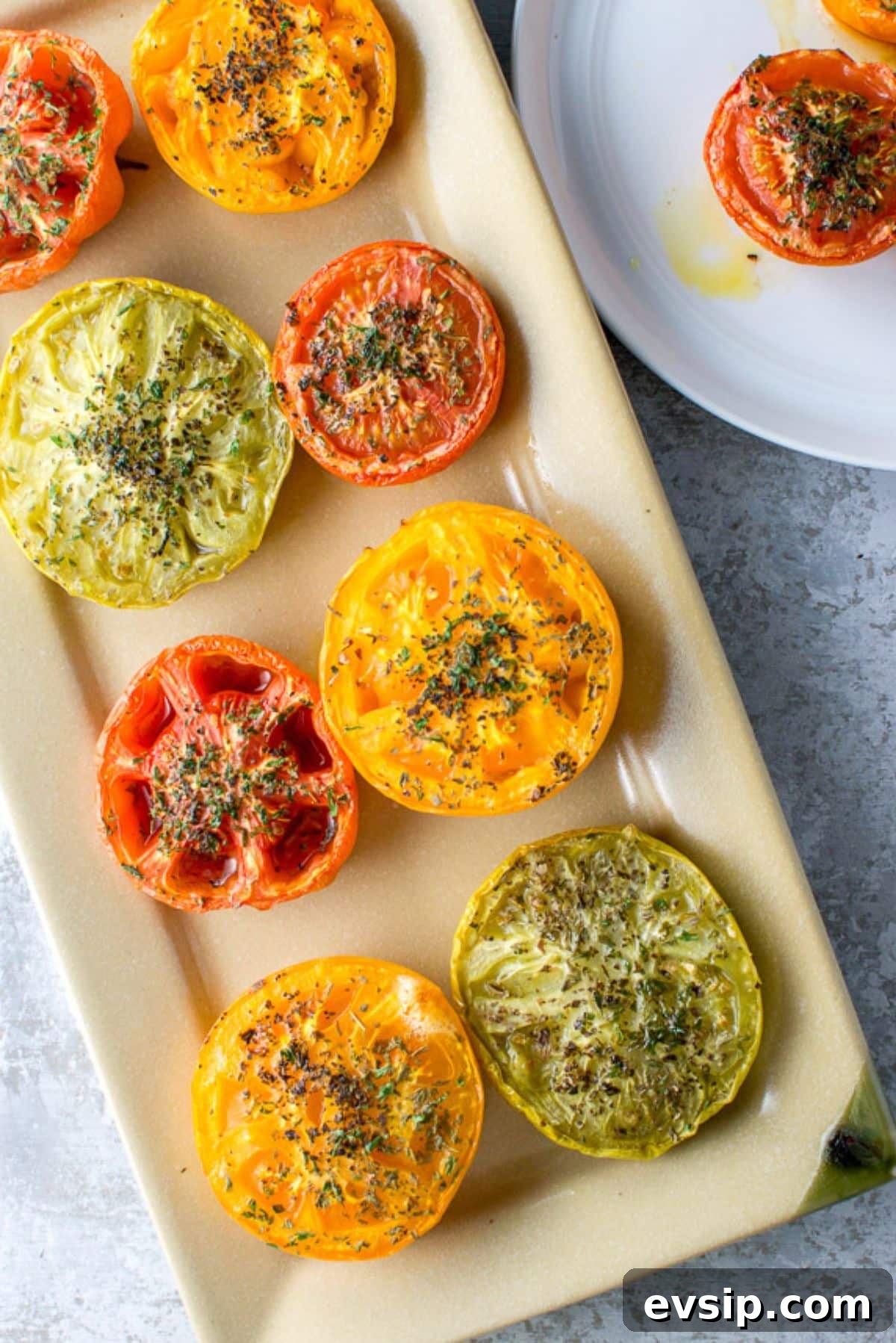 Sweet Baked Tomatoes with Honey-Glazed Juiciness 8 Overhead view of the rectangle platter with tomatoes with herbs on it