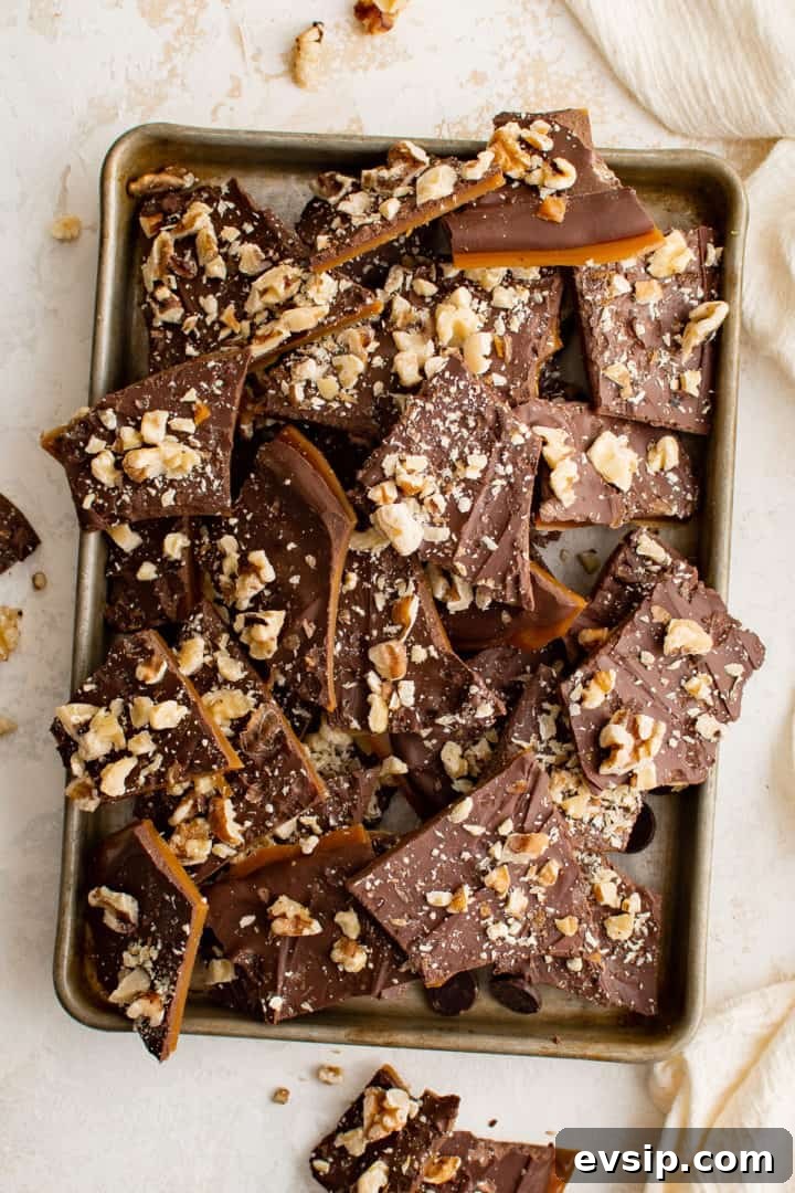 Top down view of English toffee topped with melted chocolate and nuts.