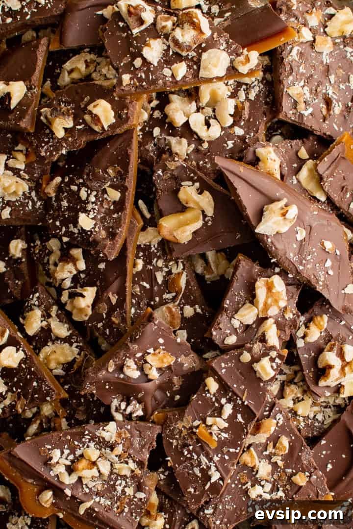 Close up view of toffee with chocolate and walnut pieces.