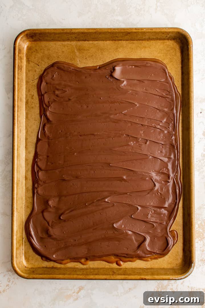 Melted chocolate spread over cooled toffee.