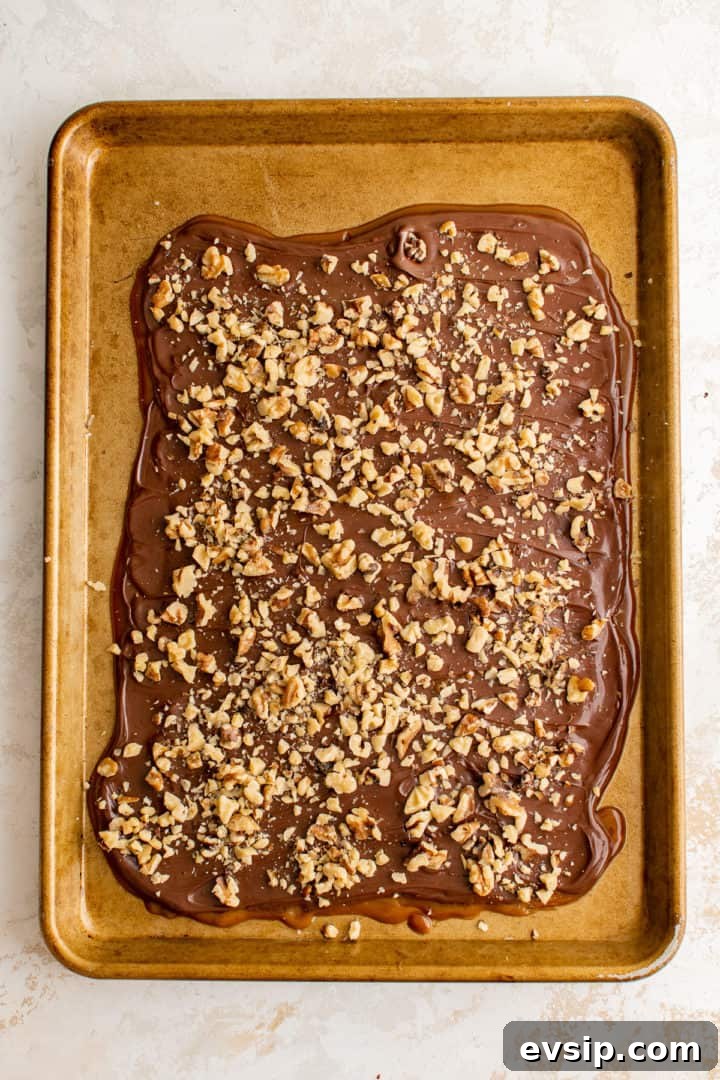 Nuts sprinkled over warm English toffe.