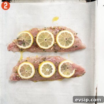 Crispy Baked Red Snapper with Lemon and Herbs 6 Red snapper placed on a baking tray with parchment paper.