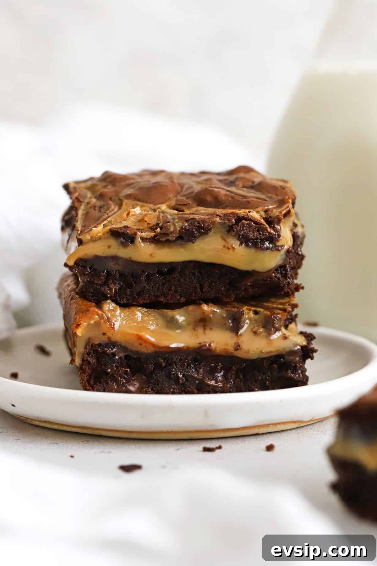 gluten-free dulce de leche brownies stacked on a white plate