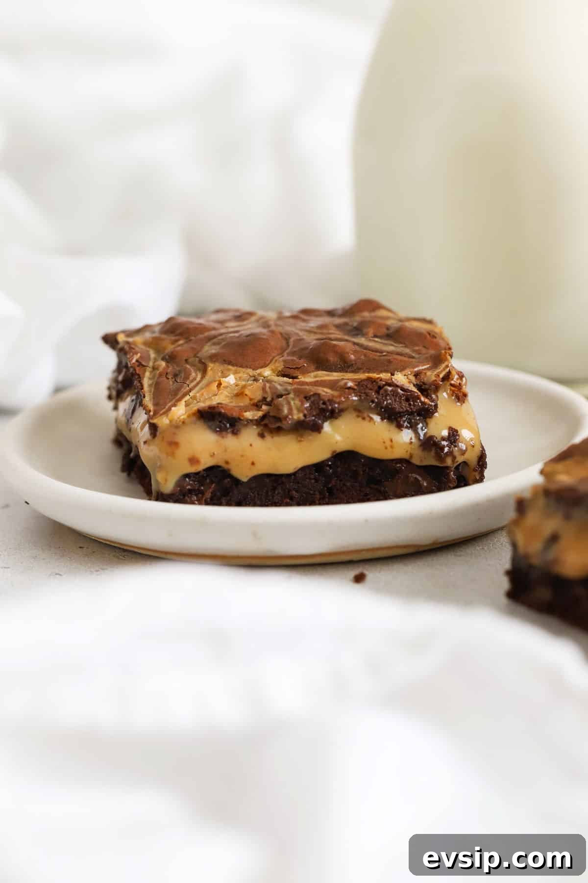 a gluten-free dulce de leche brownie square on a white plate