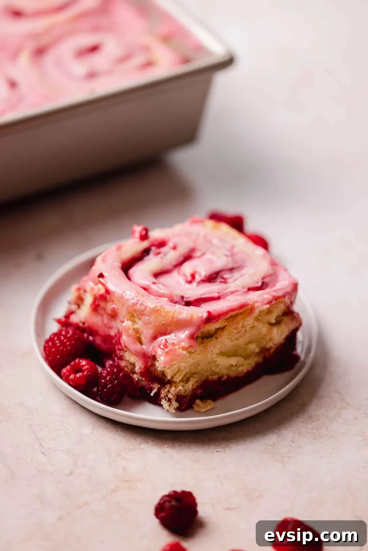Gooey Raspberry Rolls Recipe: Soft, Homemade Pastry 7 raspberry roll on small plate with fresh raspberries