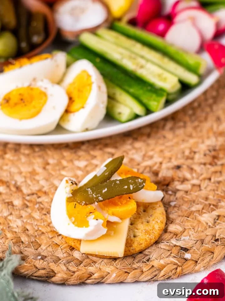 cracker, cheese, hard boiled egg, small pickle and flaky sea salt