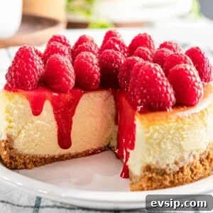 Silky Raspberry Cheesecake Recipe with Fresh Berry Glaze 16 Raspberry cheesecake with fresh raspberry topping and raspberry sauce.