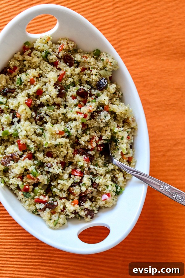 an overview photo of quinoa with finely chopped, colorful vegetables and raisins