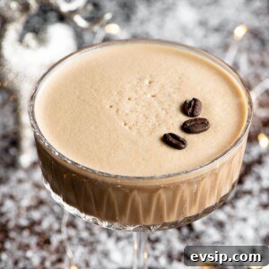 A close up of a Martini Macchiato cocktail in a glass topped with coffee beans