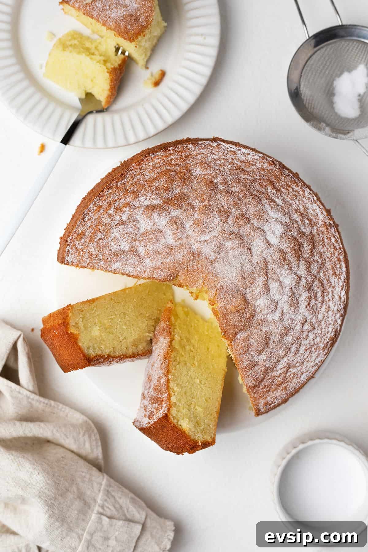 Sliced olive oil sponge cake on a serving plate.