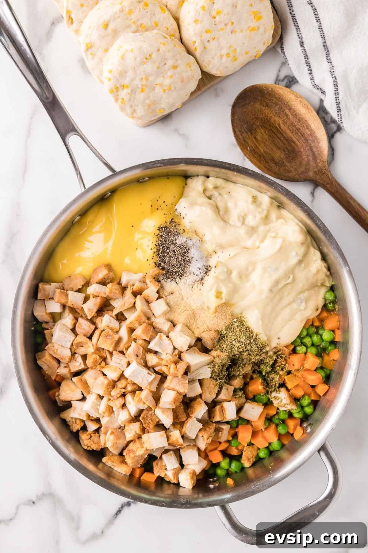 Chicken pot pie casserole filling ingredients added to a large skillet