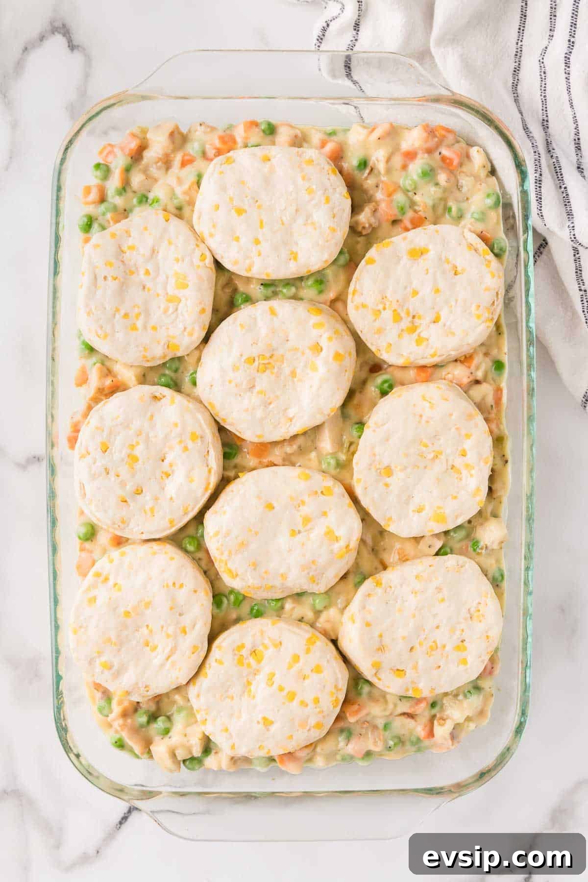 Refrigerated biscuits are evenly layered over the pot pie filling