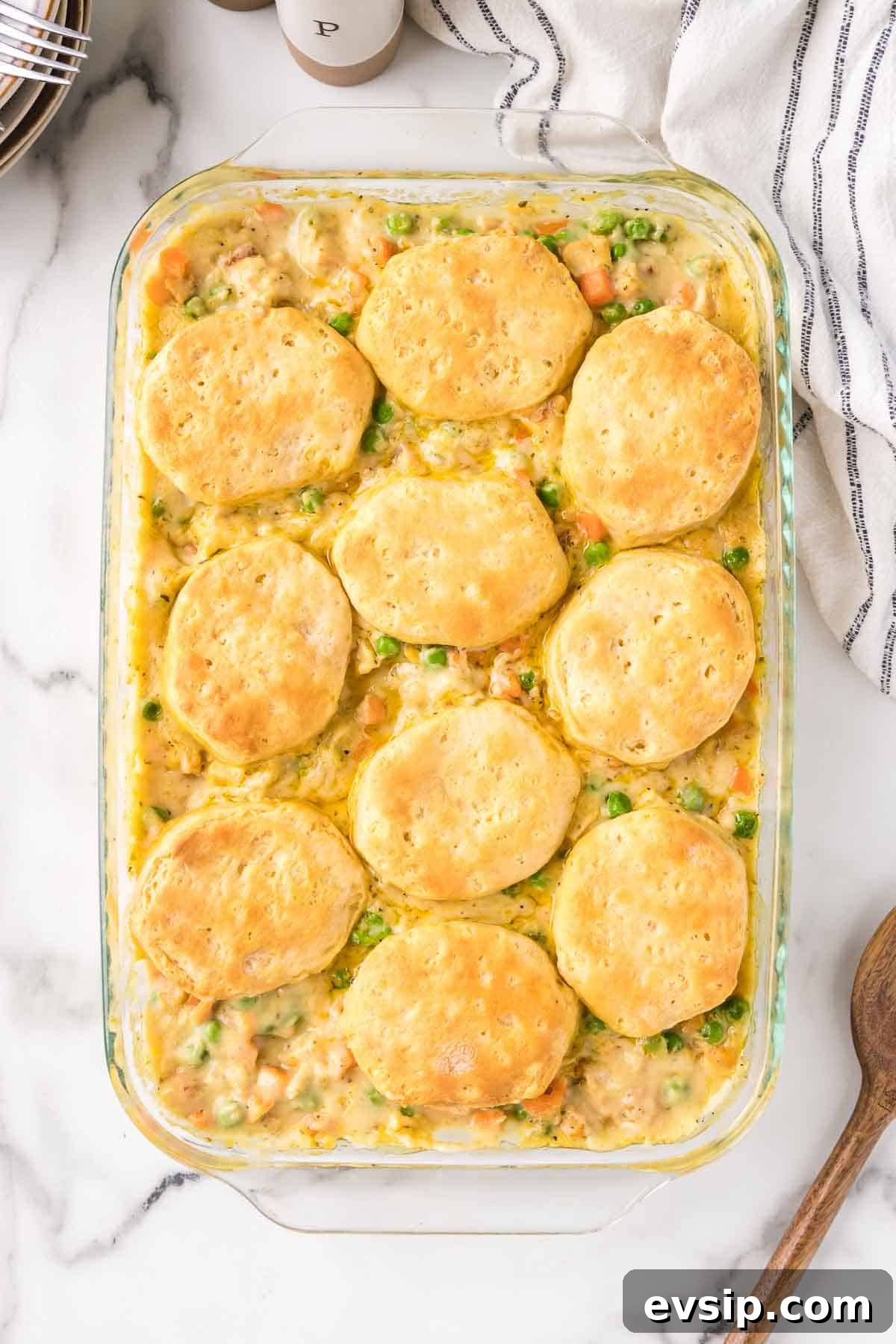 Chicken pot pie casserole is baked until the biscuits are golden