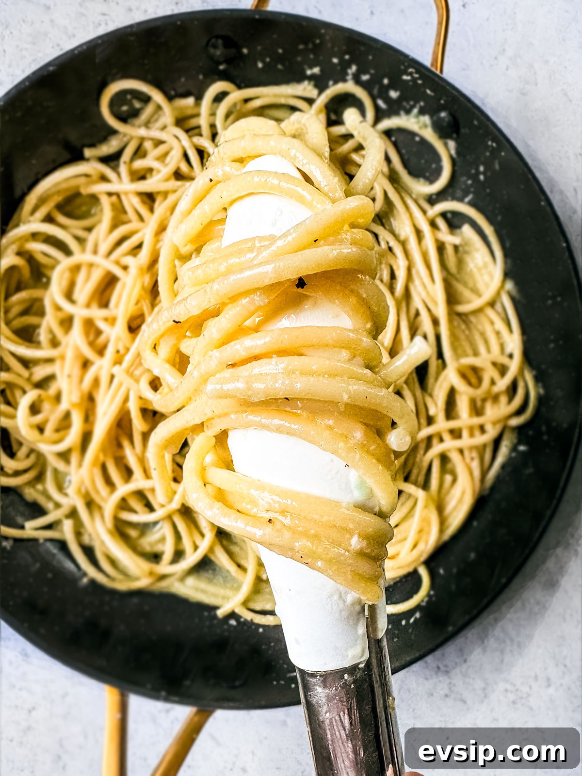 Lemon Shrimp Pasta al Limone — Creamy Citrus Pasta Recipe 5 Creamy noodles are being tossed in a pan with tongs.