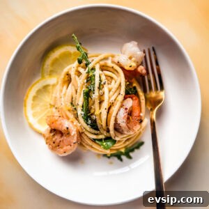 Lemon Shrimp Pasta al Limone — Creamy Citrus Pasta Recipe 7 White bowl of lemon pasta with shrimp and arugula.