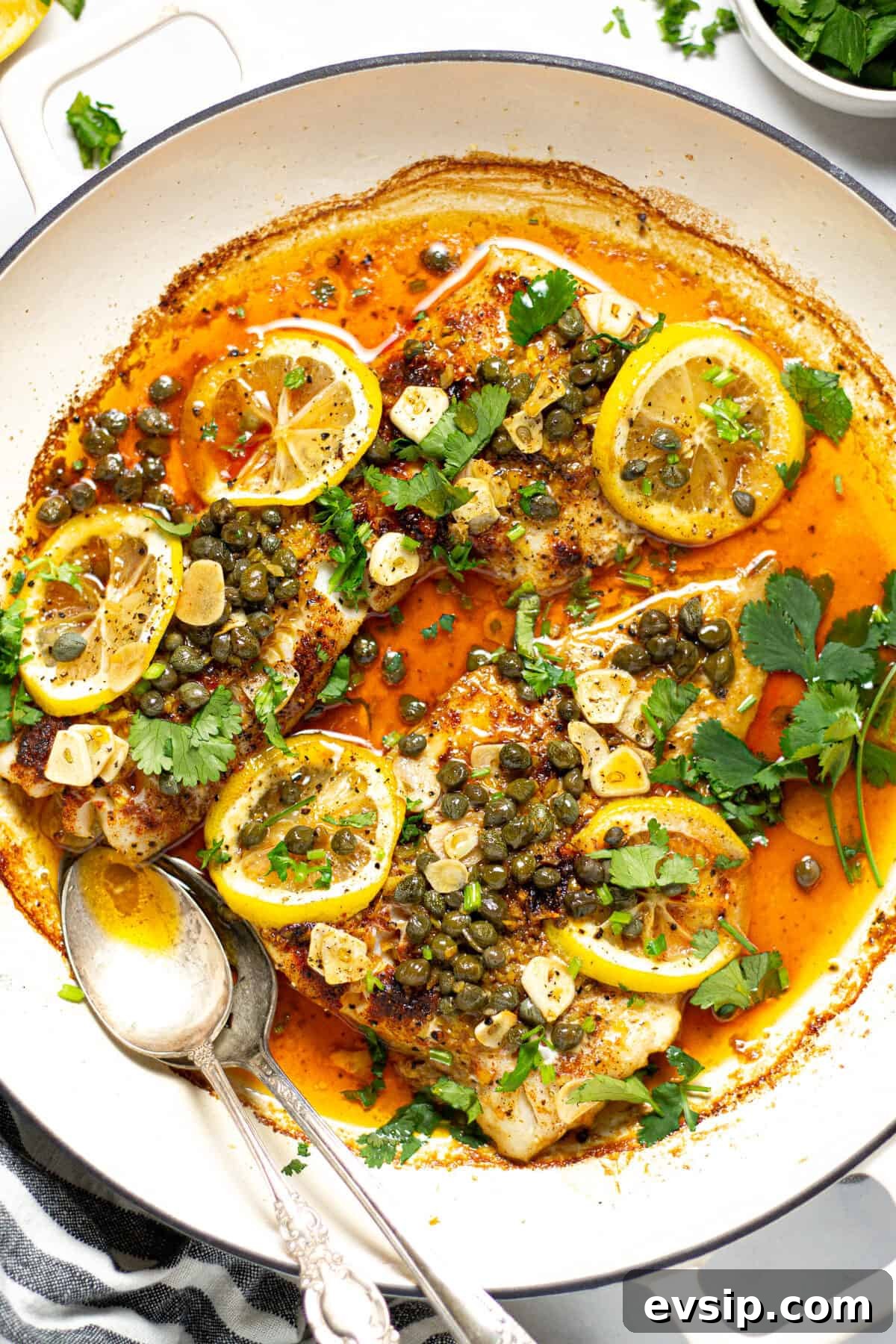Overhead shot of a pot filled with baked Mediterranean cod garnished with fresh cilantro