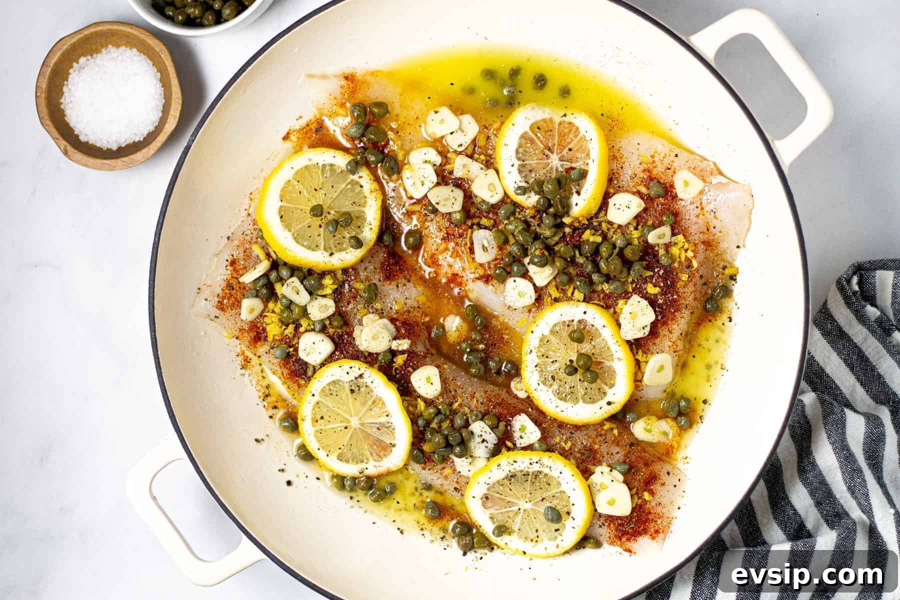 Overhead shot of a pot filled with baked Mediterranean cod garnished with fresh cilantro