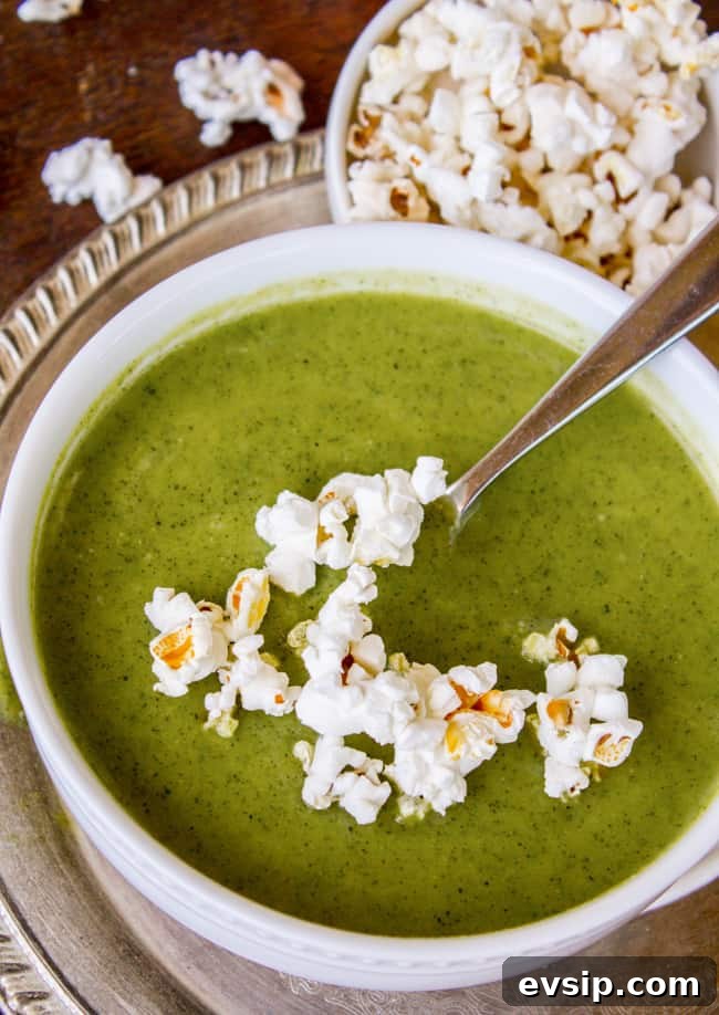Creamy Zucchini Soup Topped with Crunchy Popcorn Garnish 4 creamy zucchini soup with popcorn on top.