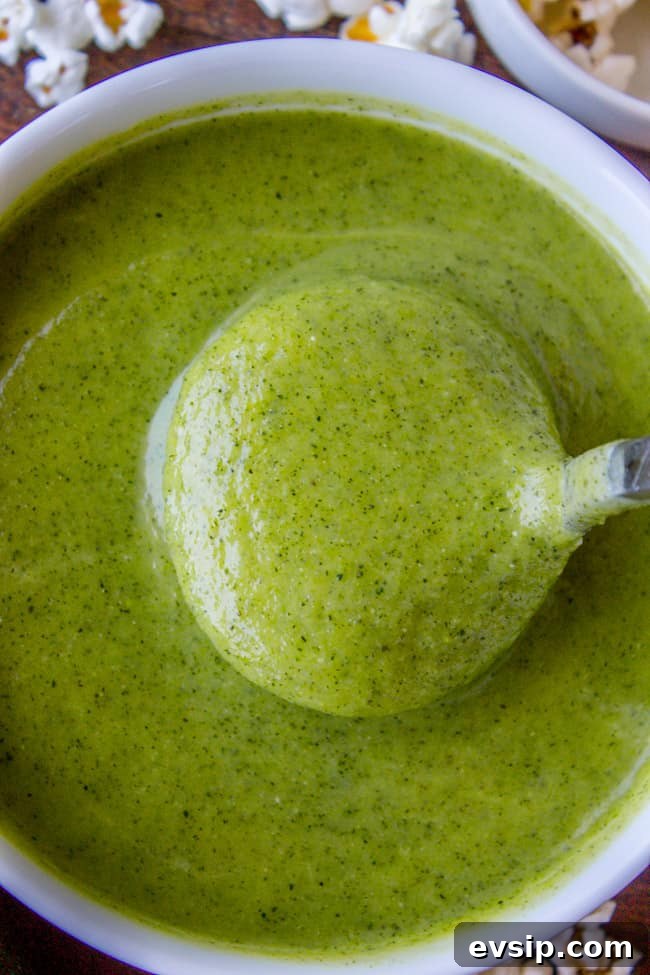 Creamy Zucchini Soup Topped with Crunchy Popcorn Garnish 9 a spoonful of creamy zucchini soup.