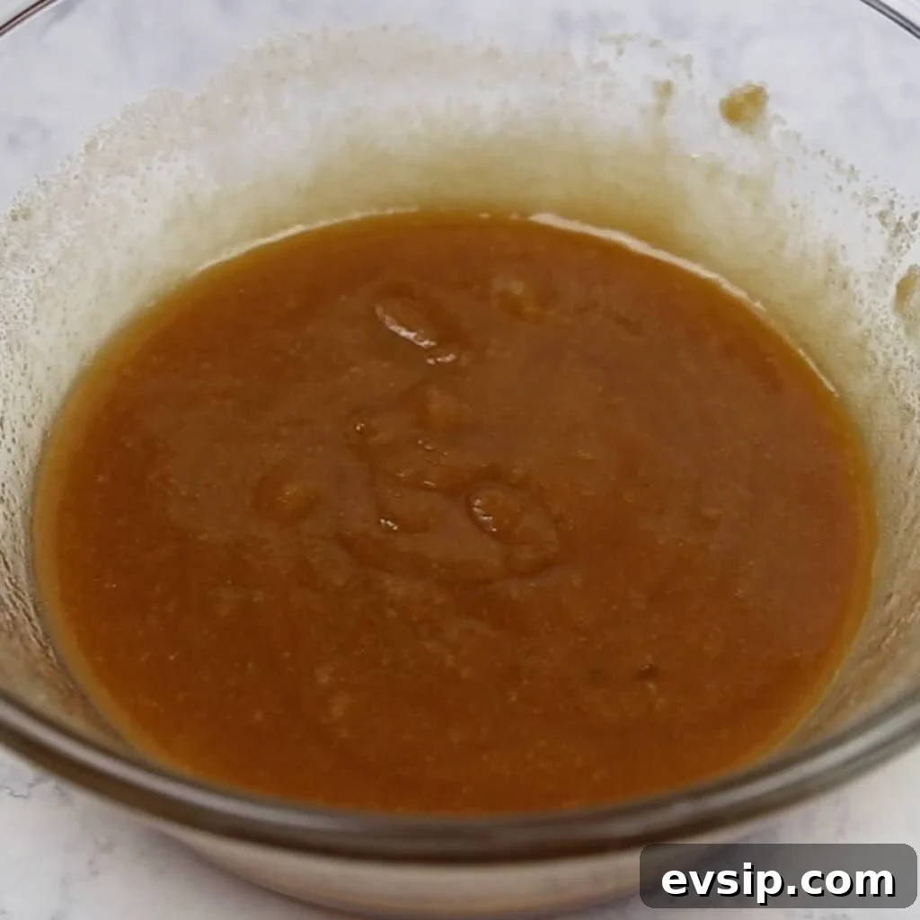 Sauce of brown sugar, Jim Beam Red Stag and Hot sauce all mixed together in a bowl.