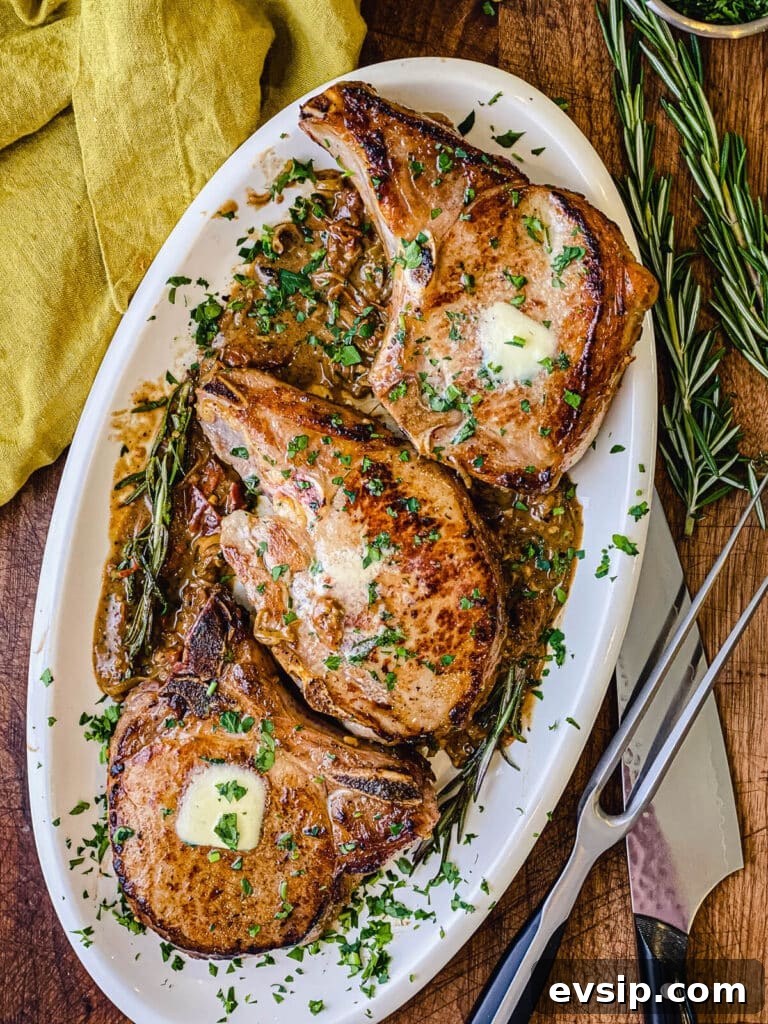 Pan-Seared Pork Chops with Rustic Sun-Dried Tomato Sauce 8 platter of pan seared pork chops with a knife and cutting prong