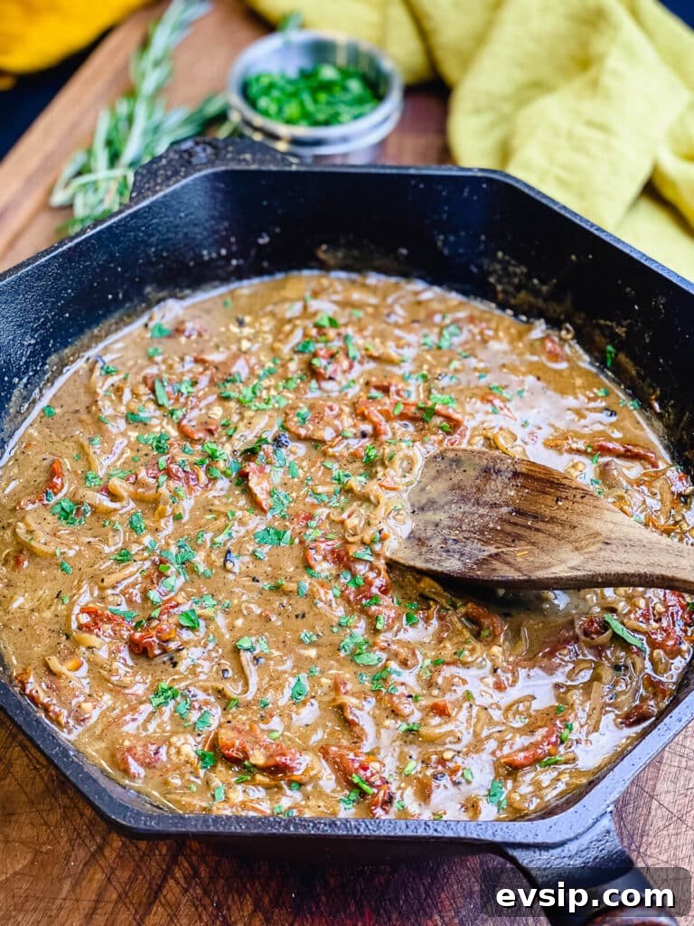 Pan-Seared Pork Chops with Rustic Sun-Dried Tomato Sauce 7 sun dried tomato sauce in a cast iron pan