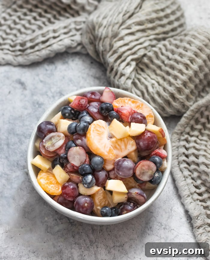 Creamy fruit salad in bowl