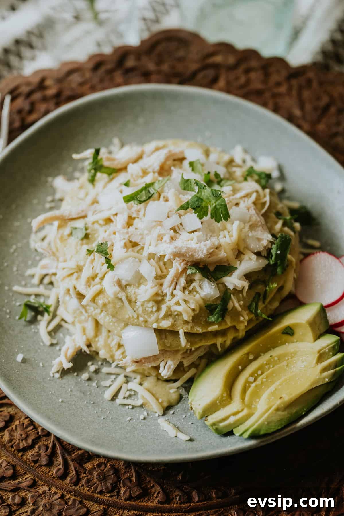 Authentic Green Enchiladas (Enchiladas Verdes) Recipe for Dinner 2 Stack of enchiladas verdes layered with shredded chicken, shredded white cheese, and a creamy roasted green chile sauce, and garnished with cilantro.