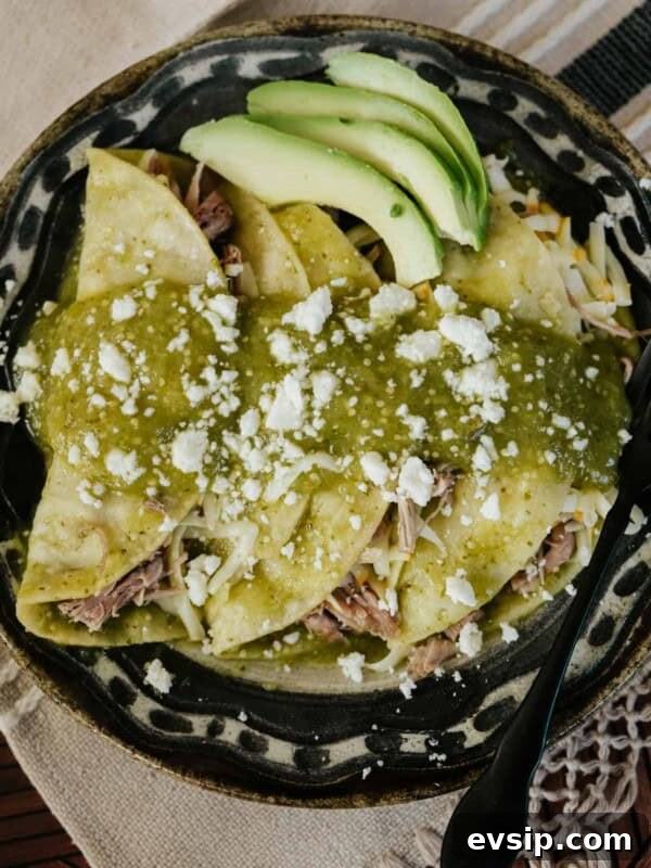 Authentic Green Enchiladas (Enchiladas Verdes) Recipe for Dinner 15 black and tan plate filled with 3 pulled pork enchiladas verdes.
