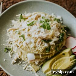 Authentic Green Enchiladas (Enchiladas Verdes) Recipe for Dinner 18 Stack of enchiladas verdes layered with shredded chicken, shredded white cheese, and a creamy roasted green chile sauce, and garnished with cilantro.
