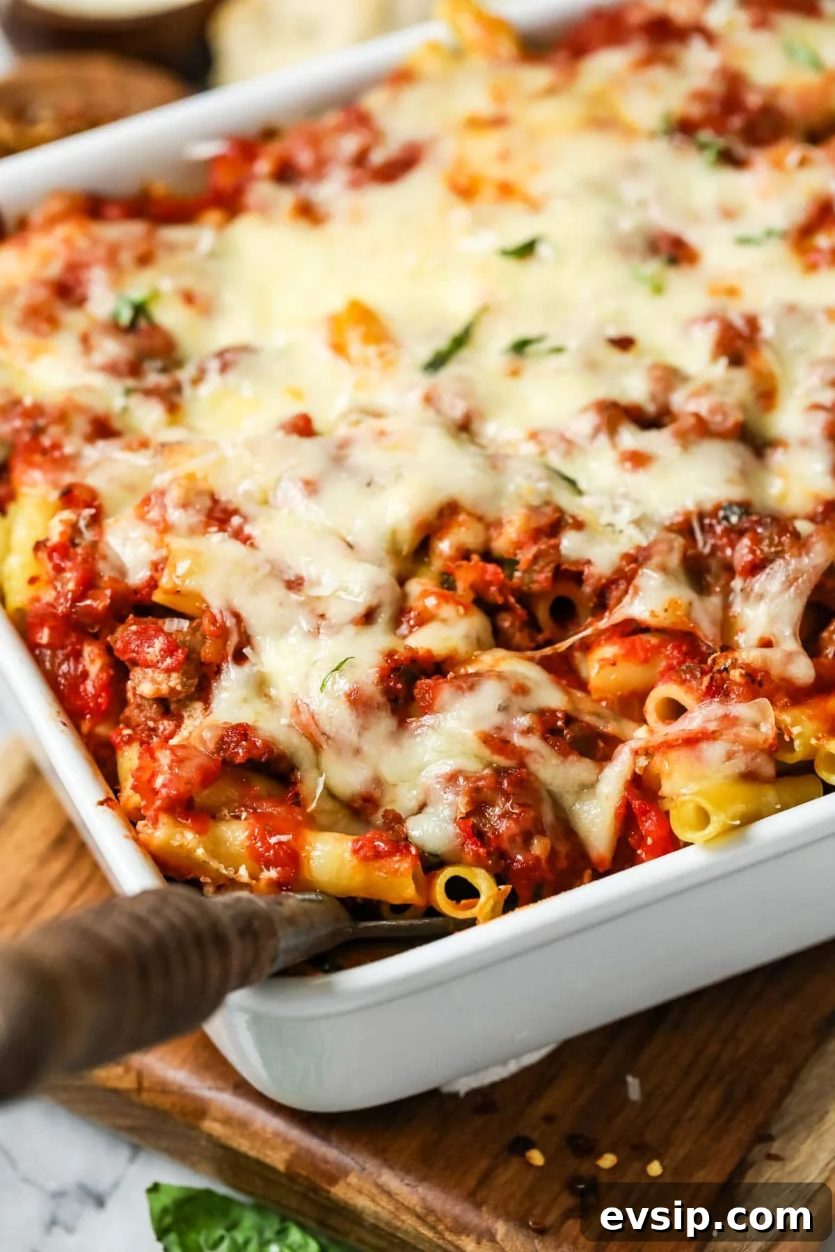 Classic Baked Ziti with Melty Cheese and Italian Sausage 3 Close-up view of baked ziti in a baking dish.