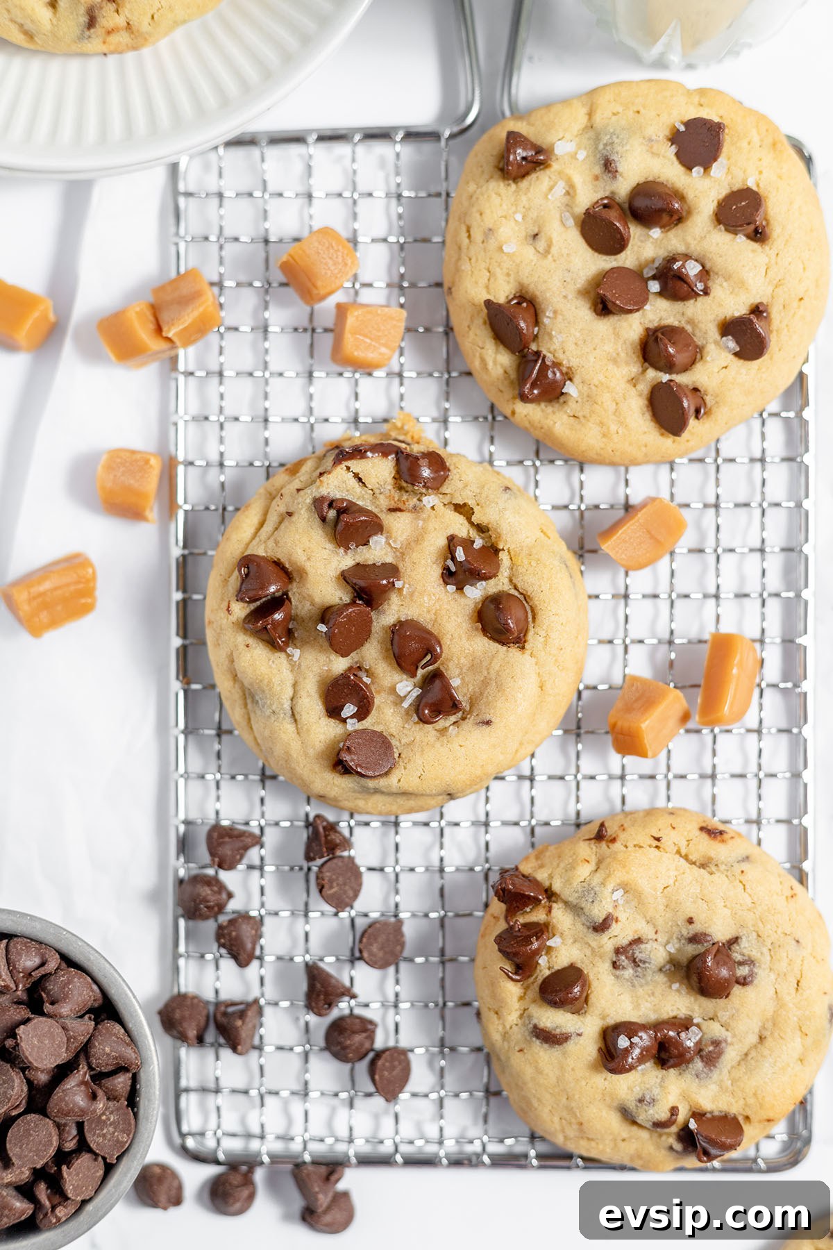 Caramel-stuffed chocolate chip cookies on a wire rack.