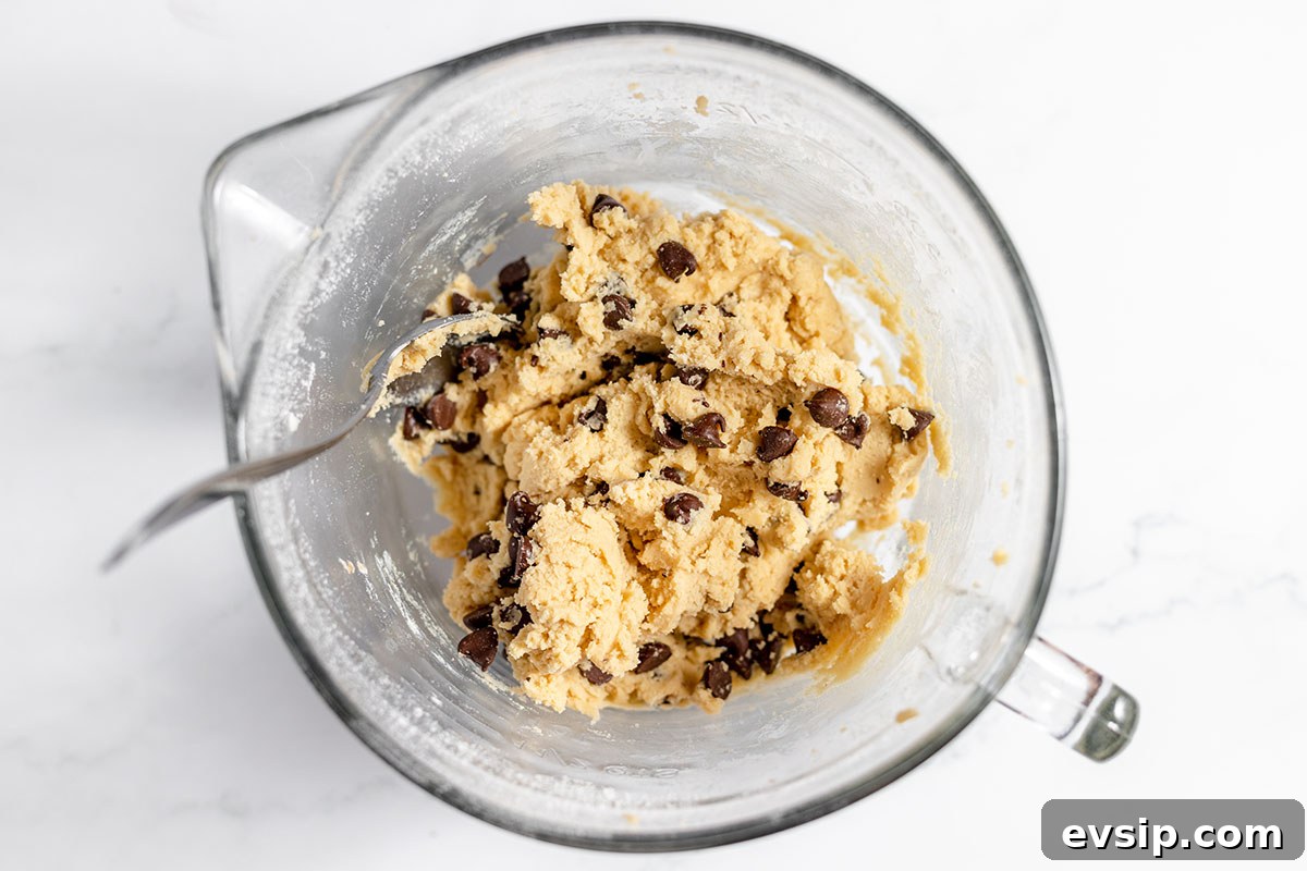 Chocolate chip cookie batter in the mixing bowl.