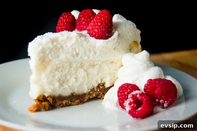 Vanilla Bean Cheesecake is a Cheesecake Factory Copycat recipe. It is so rich and creamy! #cheesecake #vanillabean #cheesecakefactory #recipe Vanilla Bean Cheesecake with raspberries.