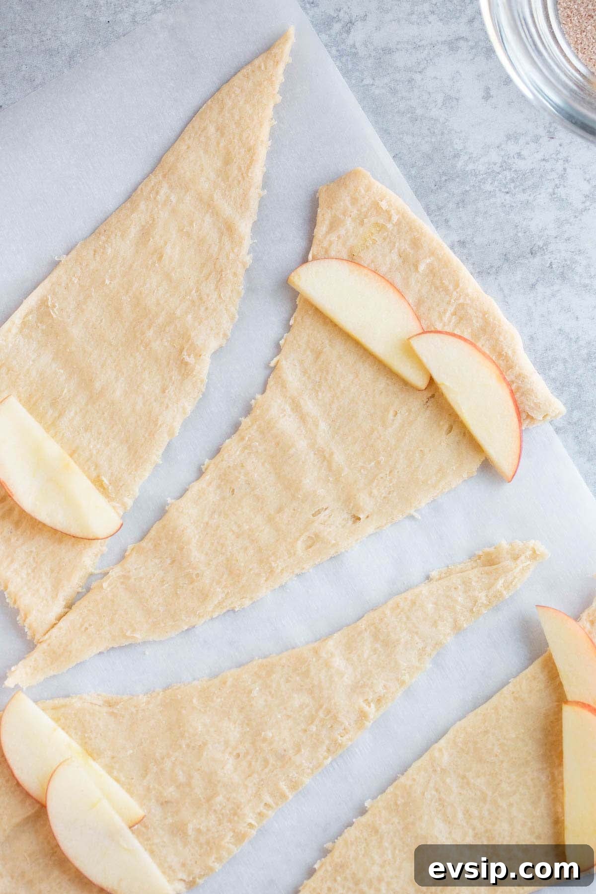 Adding apple slices to crescent rolls