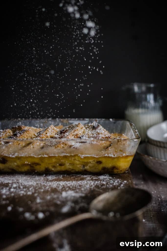 Gluten-Free Bread and Butter Pudding Recipe — Cozy Dessert Guide 10 icing sugar being sprinkled on bread and butter pudding