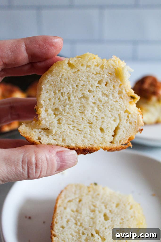 Gluten-Free Dairy-Free Parmesan Pull-Apart Rolls 3 hand holding a gluten free parmesan roll.